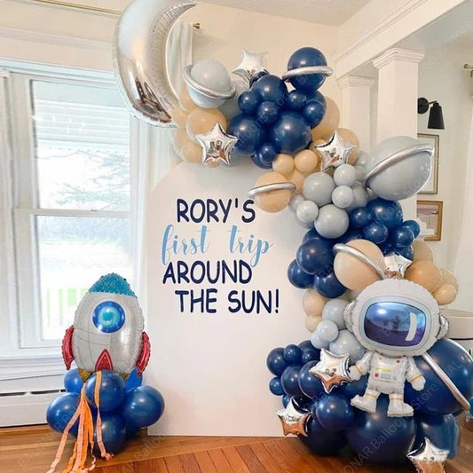 Customizable Board Backdrop with Balloon Blue and Beige with Astronaut, Moon, Silver Stars and Rocket Accents Setup - Galaxy-Themed Perfect for special occasions