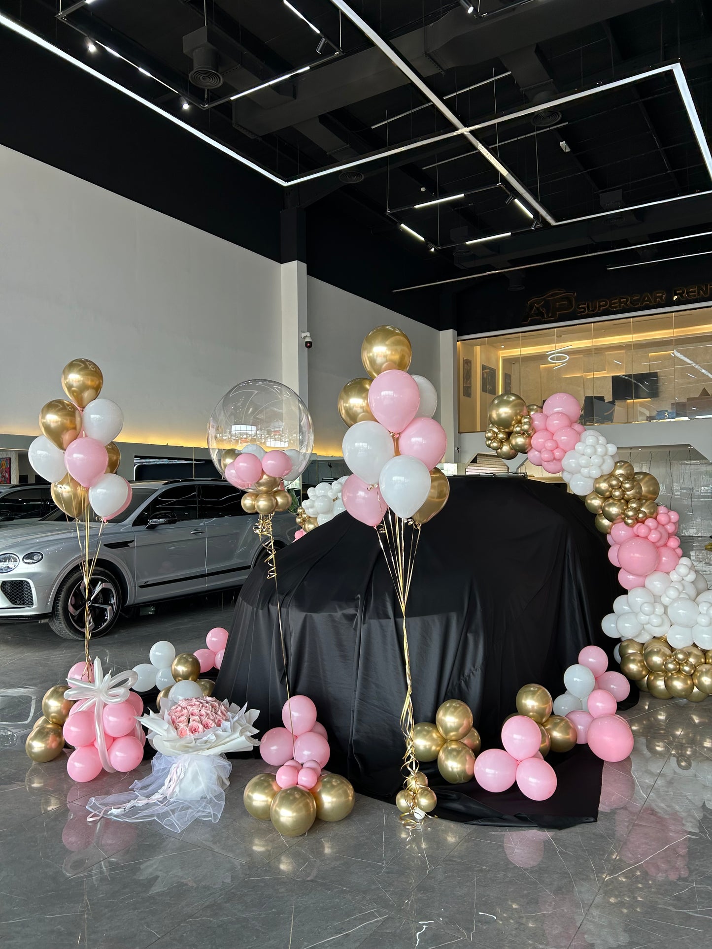 Car Surprise Balloon Design Light Gold, White and Pink with Personalised Helium, Helium Latex Bunch, Red Carpet and Bouquet Fresh Flower Accents – Perfect for Any Sleek and Elegant Celebrations