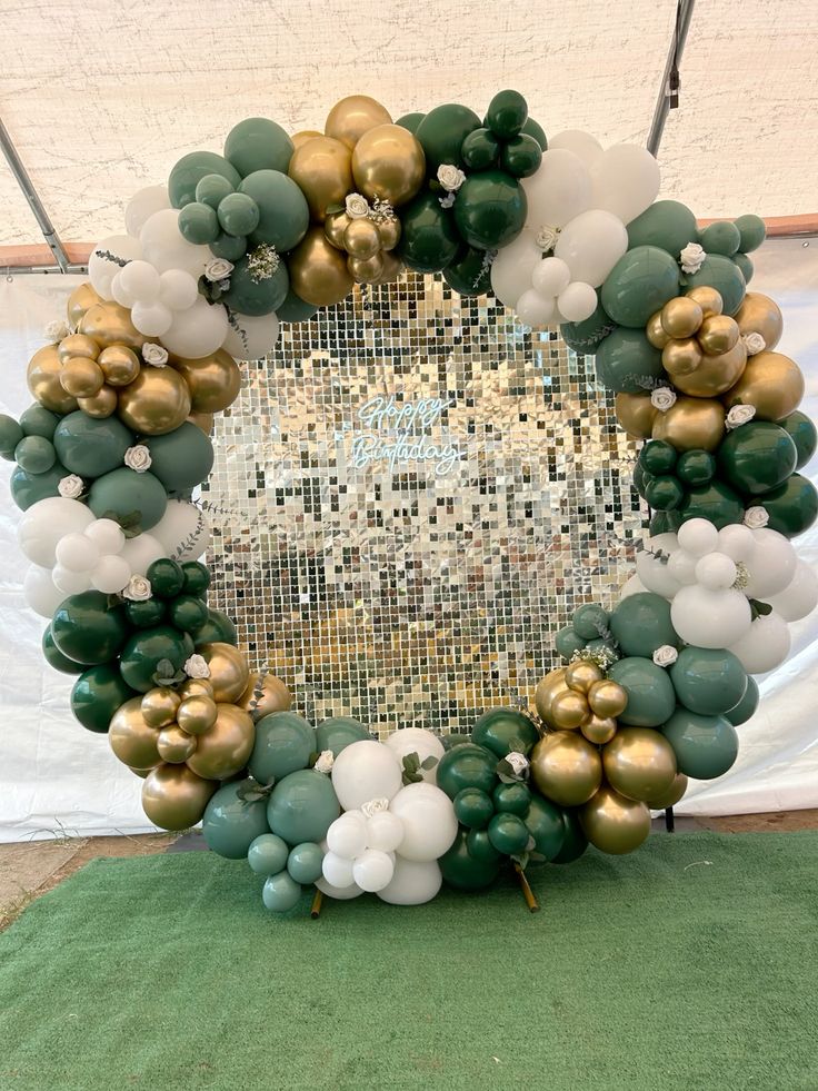 Gold Shimmer Wall with LED Acrylic 'Happy Birthday' and Round Stand with Organic Arrangement Garland Balloon Green, White and Light Gold with Artificial Flowers accents - Perfect for special occasion