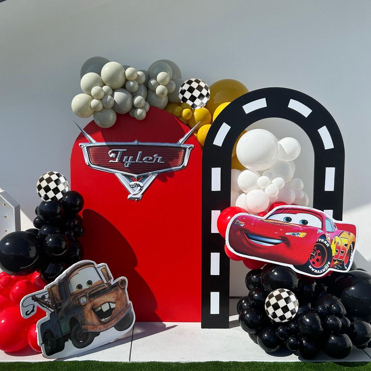 Customizable Backdrop with Balloons White, Yellow, Red, Gray and Black with Cars Character, Wheels and Checkered Ball Foil Accents - Cars-Themed Perfect for special occasions