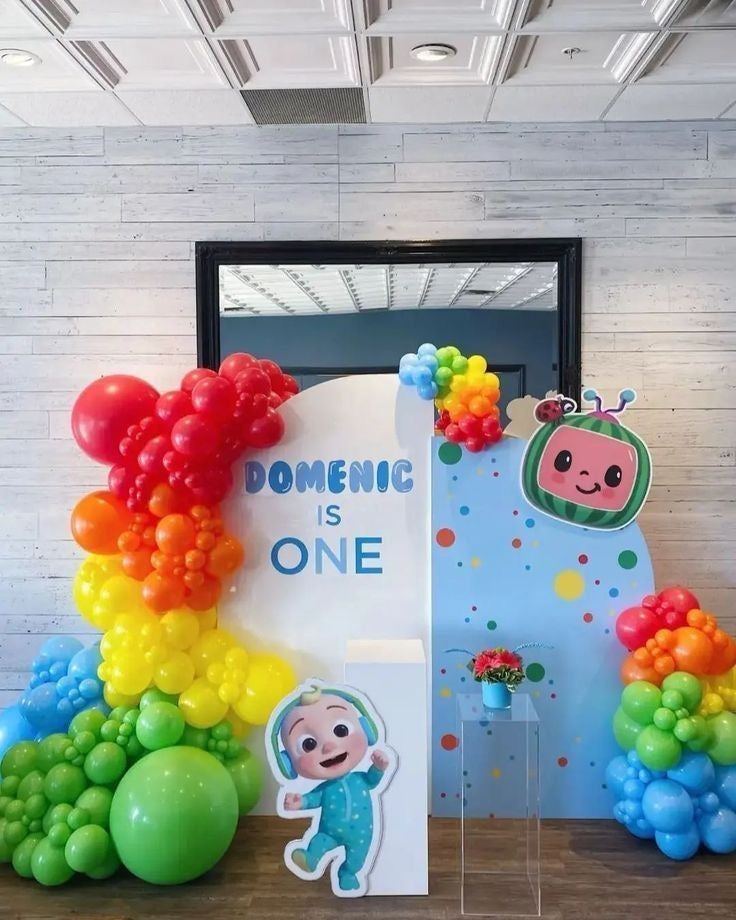 Customizable Board Backdrop with Balloon Blue, Yellow, Orange, Green and Red with JJ Character Standee and White Cake Stand - Cocomelon-Themed Perfect for special occasions