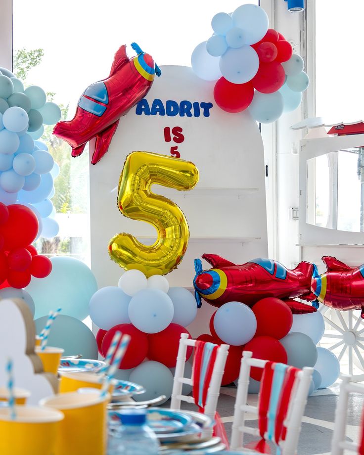 Customize Board Backdrop with Balloon White, Blue and Red with Balloon on Stand Plane Foil and Gold Number '5' Helium accents Aircraft-Themed Decor – Soar Into Celebration!