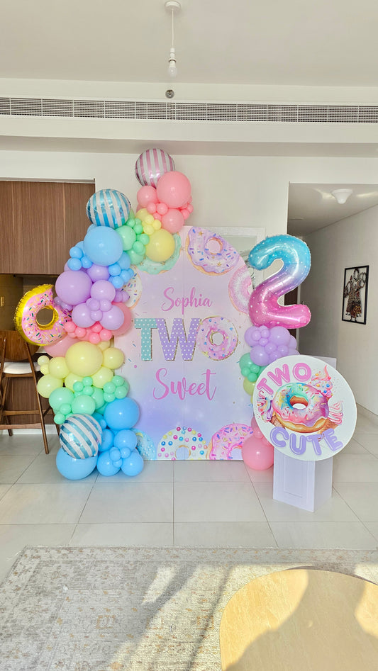 Customizable Board Backdrop ‘Two Sweet’ with Balloons Pink, Blue, Green, Purple and Yellow with Foil Candy, Donut and Number ‘2’ with Cake Stand and Customize Cutout ‘Two Cute’ - Perfect for special occasion