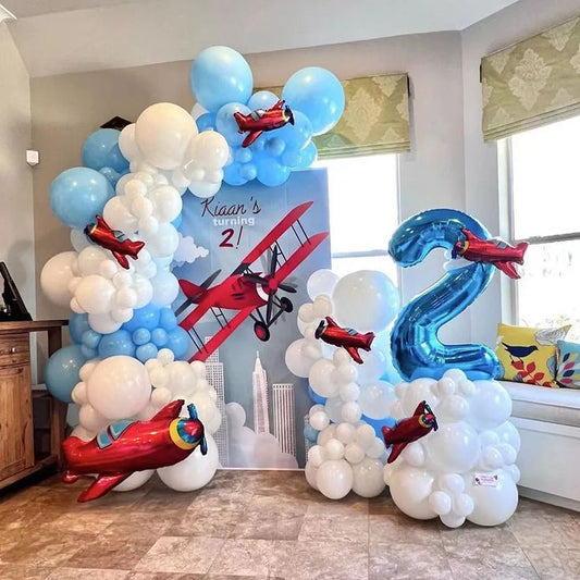 Customize Board Backdrop with Balloon White and Blue with Plane Foil accents and Number '2' Balloon on Stand Aircraft-Themed Decor – Soar Into Celebration!