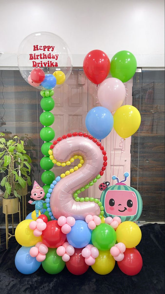 Platform Red Number '2' with Latex Blue, Green, Orange, Yellow, Purple, Red with Cocomelon and Designed Rainbow Balloons accents and Personalised Clear with Mini Latex with Customized Sticker and Helium Latex Bunch – Cocomelon-Themed Customizable Design