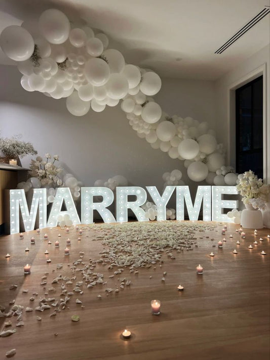 Artificial Flowers and Petals, LED Marquee 'MARRY ME', Candles and Balloons Backdrop Organic Chain Arrangement - Perfect for Proposal, Wedding, Anniversary special occasions!