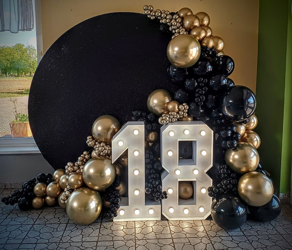 Round Customizable KT Board Backdrop with Balloon Gold and Black Decor with LED Marquee ‘18’ Lights Setup - Perfect for special occasions