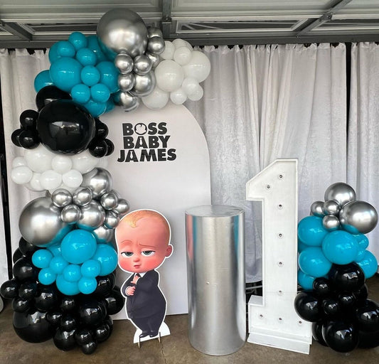 Customizable Backdrop with Balloons White, Silver, Black and Turquoise  with Baby Boss Standee, Cake Stand and LED Marquee Number ‘1’  - Boss Baby-Themed Perfect for special occasions