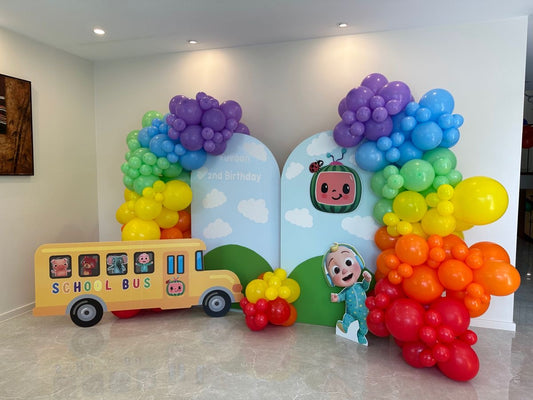 Customizable Board Backdrop with Balloon Blue, Yellow, Orange, Green and Red with JJ Character Standee and School Bus - Cocomelon-Themed Perfect for special occasions