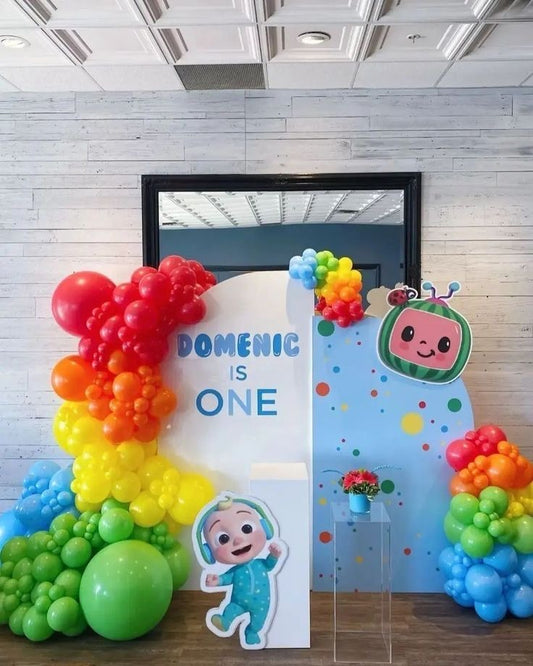 Customizable Board Backdrop with Balloon Blue, Yellow, Orange, Green and Red with JJ Character Standee and White Cake Stand - Cocomelon-Themed Perfect for special occasions