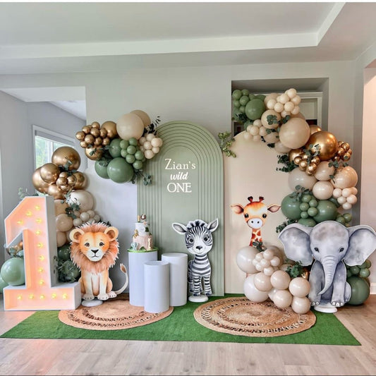 Customizable Board Jungle Backdrop with Balloon Gold, Dust White and Green with Artificial Leaves, LED Marquee ‘1’ Number, Animals in a Car Standee Lion Giraffe Zebra Elephant - Safari-Themed Perfect for special occasions