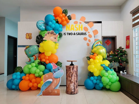 Customizable Board Backdrop with Balloon Green, Orange, Blue and Yellow with Artificial Leaves and Dinosaur Standee - Dinosaur-Themed Perfect for special occasion