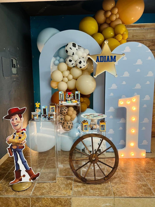 Customizable Board Backdrop with Balloon Animal Printed White, Beige, Brown, Yellow and Blue with Toy Story Character Woody Standee, LED Marquee Number ‘1’ and Acrylic Cake Stand - Toy Story-Themed Perfect for special occasions