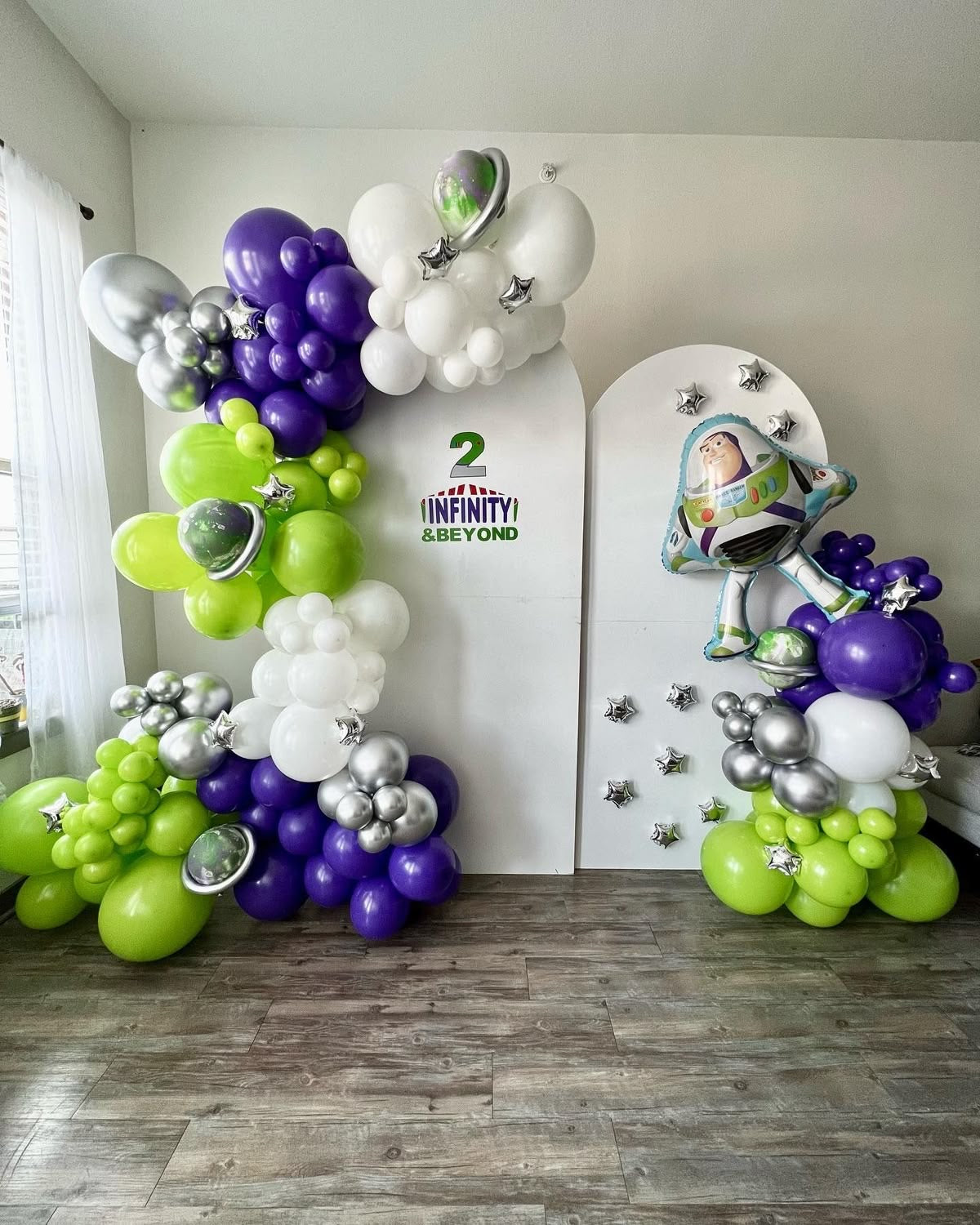 Customizable Board Backdrop with Balloons White, Green, Silver Purple and Mini Silver Stars accents and Buzz Lightyear Balloon - Toy Story-Themed Perfect for special occasions
