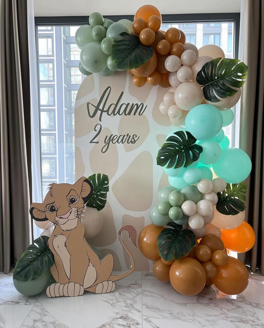 Customizable Board Jungle Backdrop with Balloon Blue, Brown and Dust White with Baby Lion Standee and Artificial Leaves - Safari-Themed Perfect for special occasions