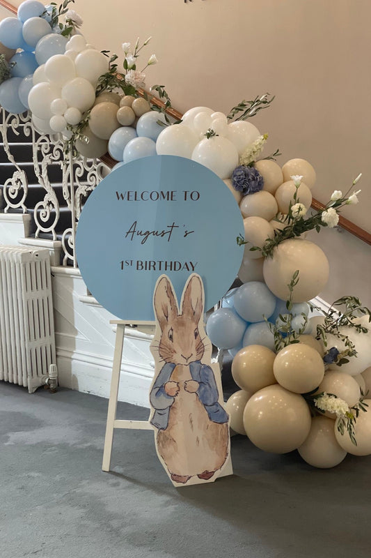 Customizable Round Board with Wooden Stand with Balloon Blue, White and Beige with Peter Standee and Artificial Flowers - The Tale of Peter Rabbit-Themed Perfect for special occasions