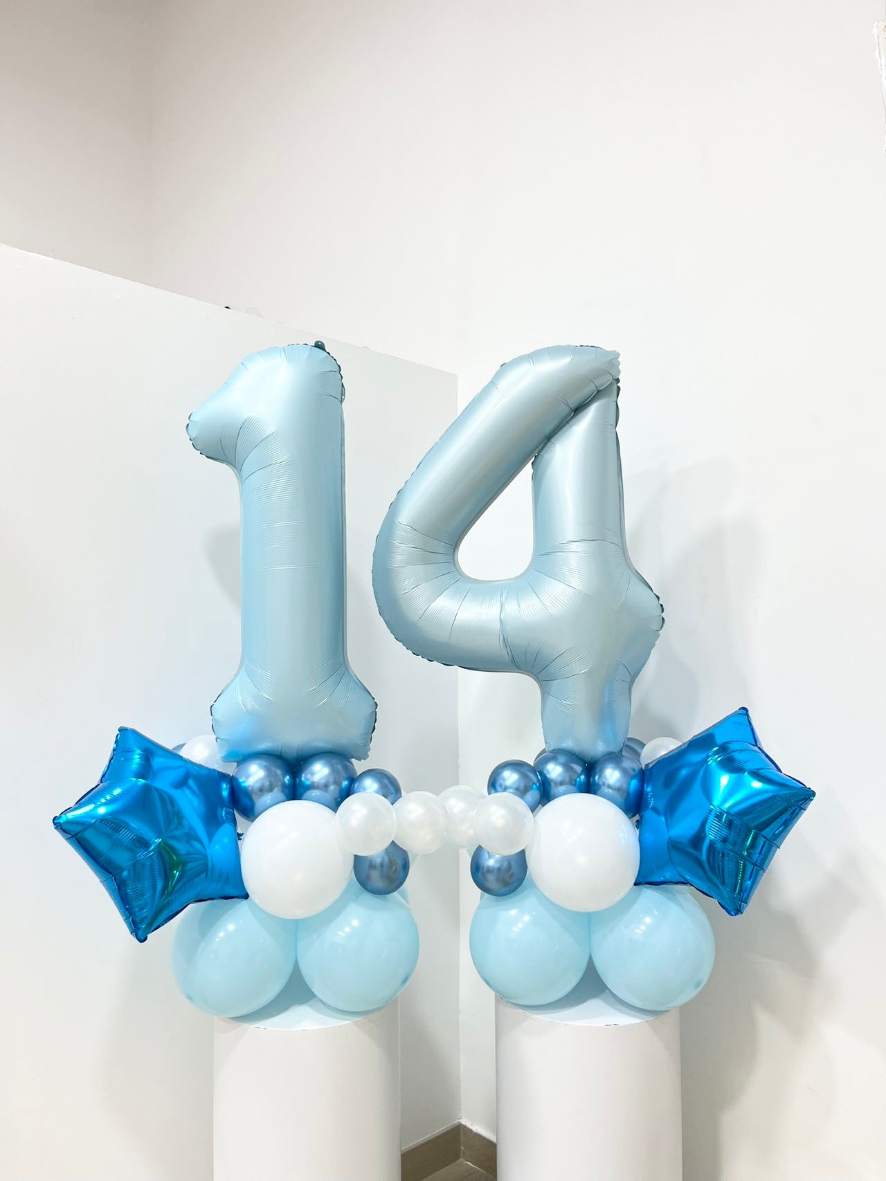 Blue Number Balloon Display with Metallic Numbers, Star Balloons, and White-Blue Balloon Base Featuring '14' Number Balloons on a Stand