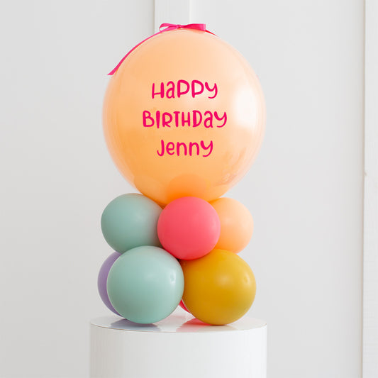 Personalised Birthday Bobo Balloon on Stand - Viridian Green, Mustard yellow, Pastel Red and Purple, Marigold Orange Clusters with Custom Name Sticker